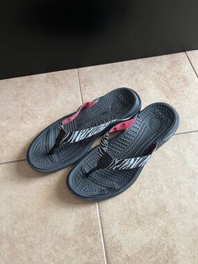 CROCS Black Flip Flops with Zebra-Print Straps and Pink Accent, size 9
